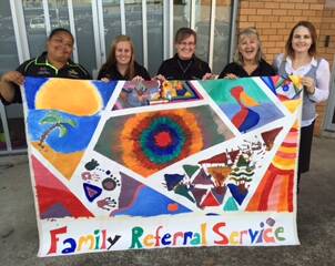 Family Referral Staff with the mural done with the children at PCYC