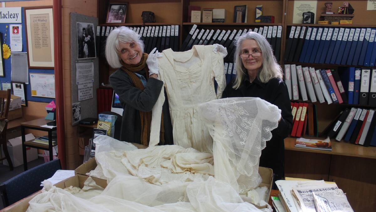 FASHIONISTAS: Co-curators Dr Noeline Kyle and Julia Morrell displaying one of the dresses featured in the exhibition.