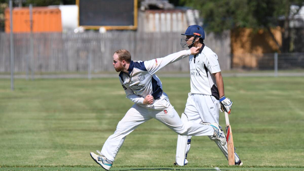 DELIVERY STRIDE: A Nulla cricketer bends his back as the Rovers' non-striker watches on at Athletics. Photo: Penny Tamblyn.