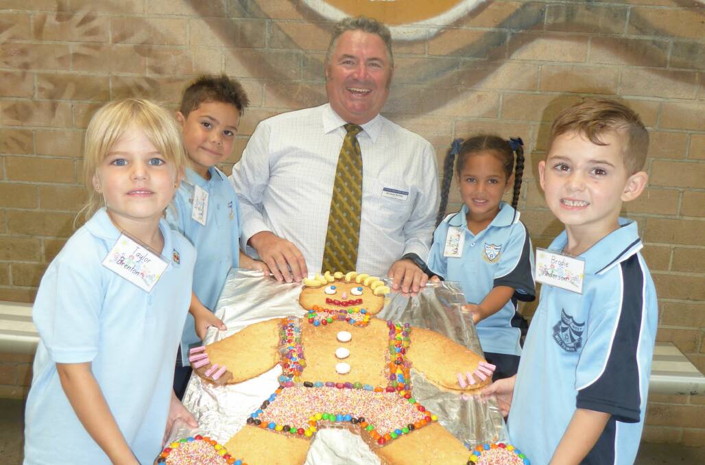 LOOK WHAT WE FOUND: Principal David Munday and kindergarten students find their man at Kempsey West Public School
