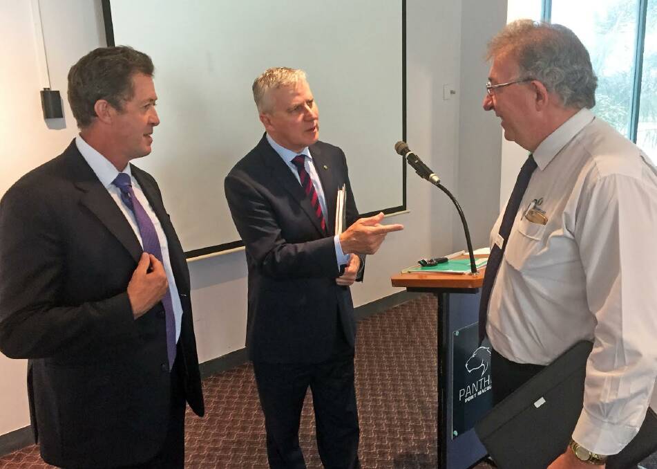 Small business rules: Cowper MP Luke Hartsuyker looks on as federal minister for small business Michael McCormack talks up small business with Holiday Coast Credit Union CEO Neville Parsons in Port Macquarie on Wednesday.
