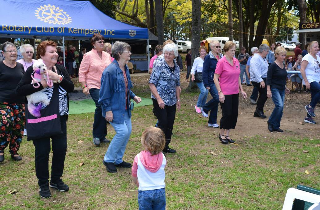 Line dancers and one special pooch entertaining a rapt audience at the Kempsey riverside markets.