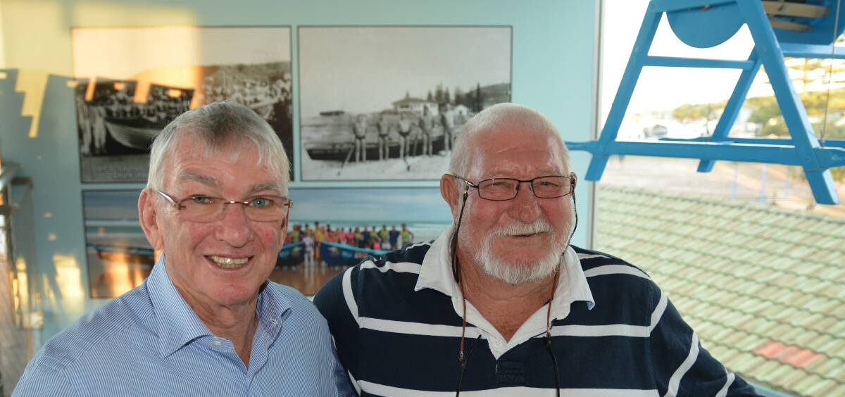 Life members of the Kempsey-Crescent Head Surf Life Saving Club Rex Williamson and Ken Clegg in front of a picture of their surf boat crew from the 1963-1964 season.