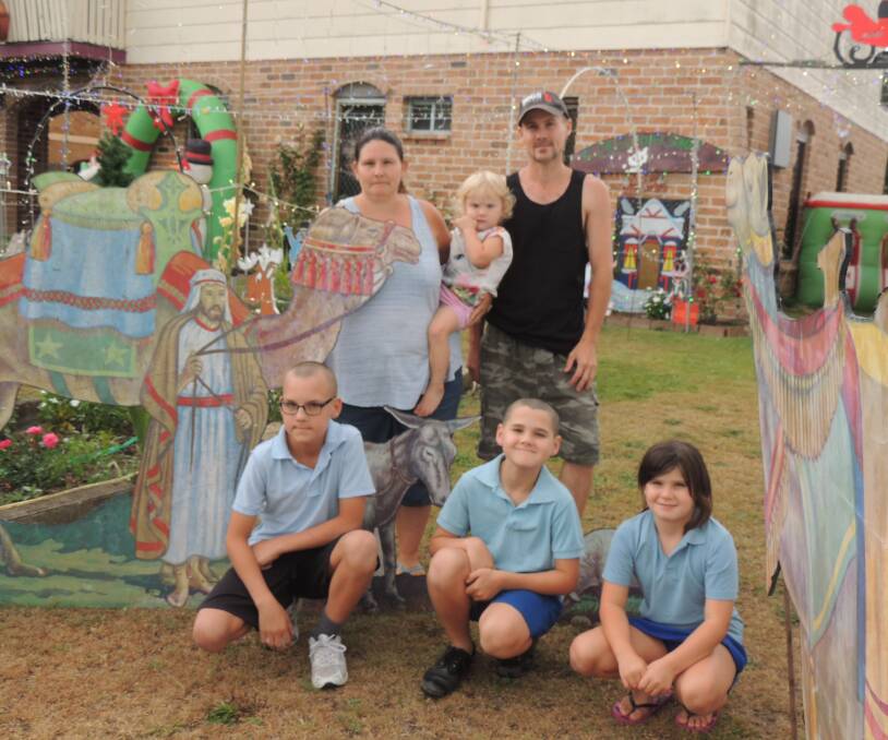 CHRISTMAS CHEER: Tara Holden and David Rixon with their children Dominic, Zachary, Amanda and Destiny outside their home on Eden Street, Kempsey. 