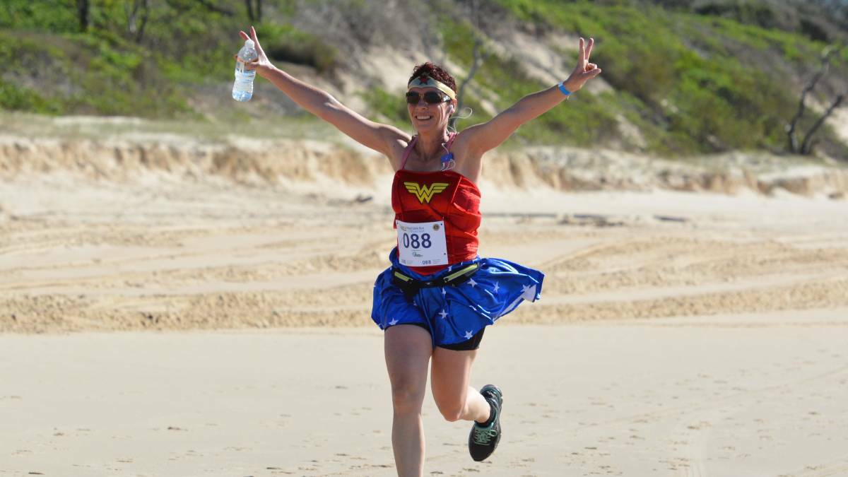 Rebecca Kings, decked out in a Superwoman outfit, finishes her run at the 2016 event. 