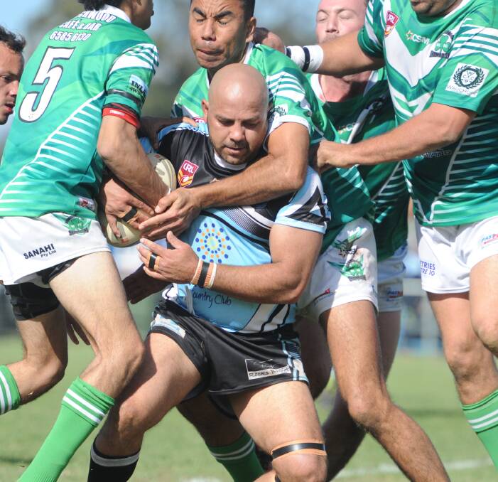 Smothered: Beechwood players descend on a Marlins ball-runner. The Beechwood Shamrocks will now take on the Lower Macleay Magpies in the minor semi-final on Sunday.