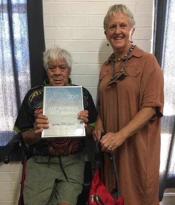 Artist award: Dunghutti Aboriginal Art Gallery co-ordinator Jann Kesby congratulating Lewis John Knox with his award, received for his winning artwork ‘Church After the Fire’. 