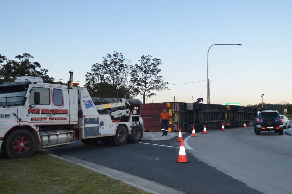 Rolled: Heavy tow trailers get into place to clear the rolled B-double on Wednesday afternoon. Photo: Lachie Leeming. 