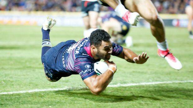 Lightning: Justin O'Neill dives over for the Cowboys in Townsville. Photo: AAP