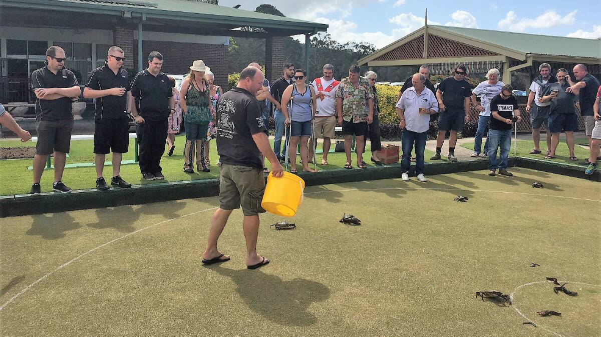 Snapping up the win: Barrier attendant Rod and the crowd at Stuarts Point workers club, look on during the crab cup at the club's annual charity bowls day on November 20.