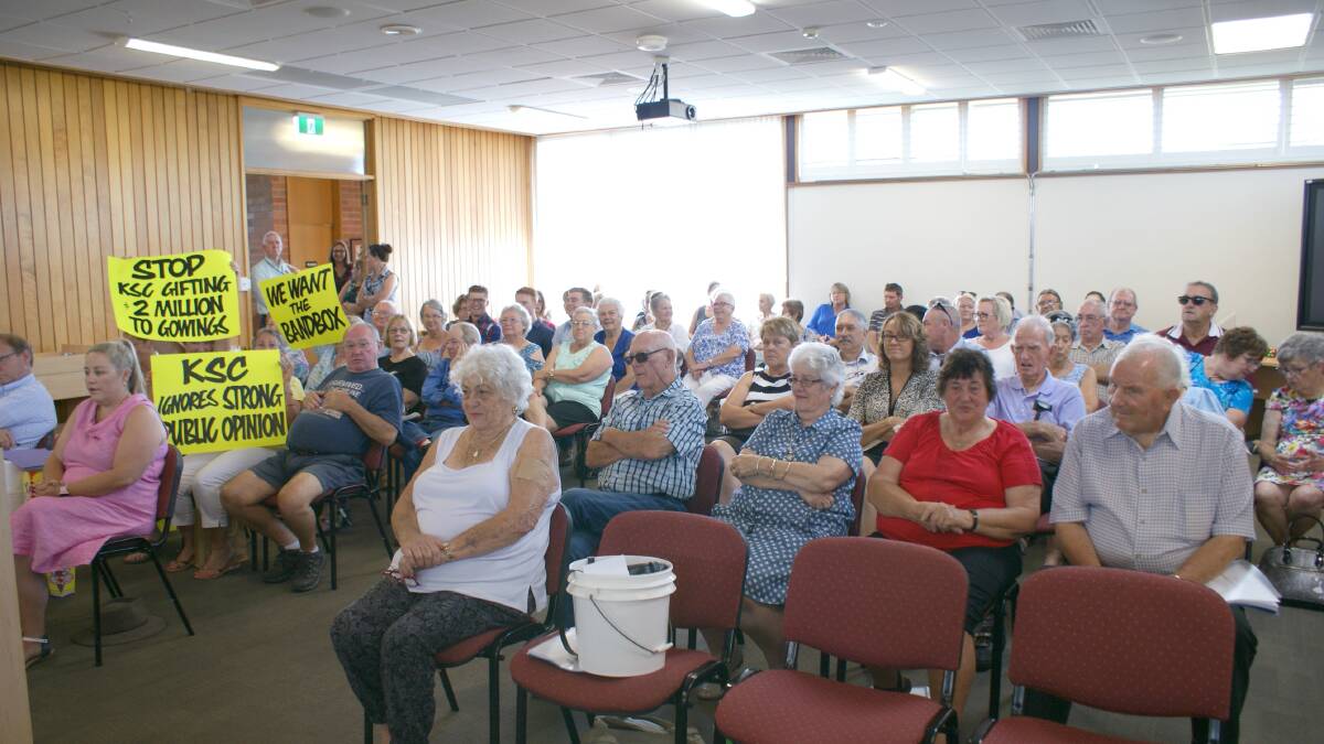 Opponents of the Kempsey Cinema held up bright, yellow protest signs in the Kempsey Shire Council chambers.