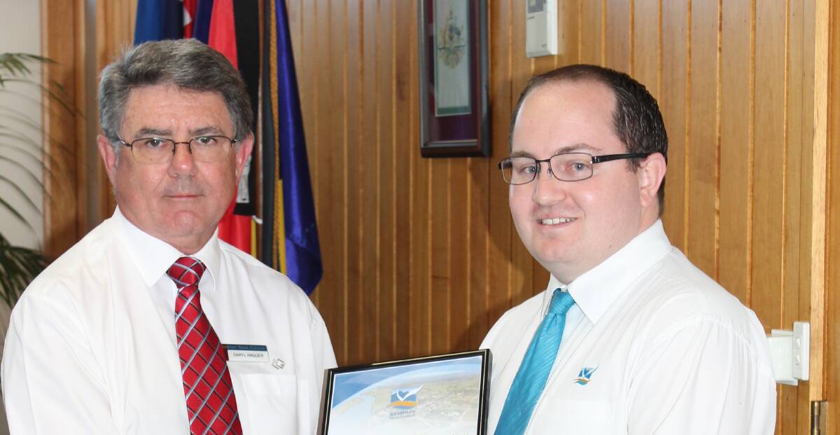 Deputy Mayor Ashley Williams receiving his certificate of oath from acting general manager Daryl Hagger.