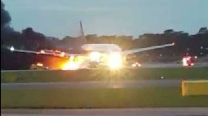 The right wing of the plane erupted in flames after it landed at Changi Airport. Photo: Twitter/@aDiLahLovatics