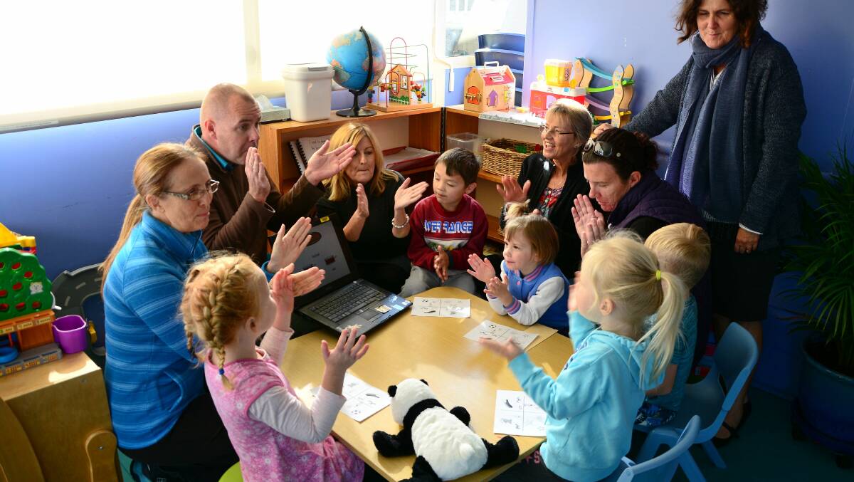 Gather round: a group of Macleay Valley early educators are angry at mooted changes to the federally funded speech pathology service, which operates at local preschools. Speech pathologist Craig Suosaari is pictured here with kids from the Lower Macleay Preschool in Smithtown and teacher-directors Pam Papalii (Upper Macleay), Debbie Dillon (Lower Macleay), Trisha DaRos (Crescent Head), Rebecca Sutherland (president of Lower Macleay Pre-school) and Cally Pratt (South West Rocks)