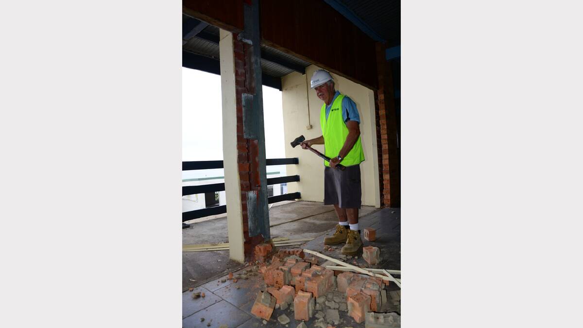 Kempsey-Crescent Head Surf Lifesaving Club stalwart Maurie Fuller lends a hand with the demolition of theold club headquarters. 