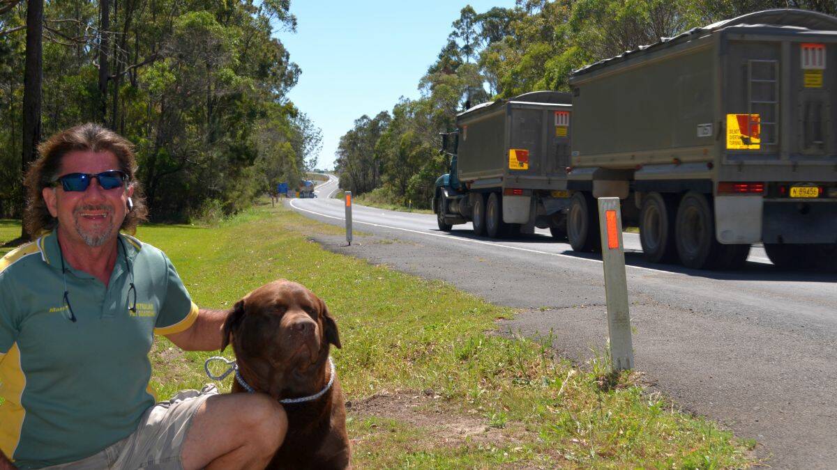 Caption: Mark Brownbill from Australian Pet Boarding is concerned about his clients’ safety during construction of the new section of Pacific Hwy from Kempsey to Kundabung. He is pictured with Samson, the chocolate labrador.