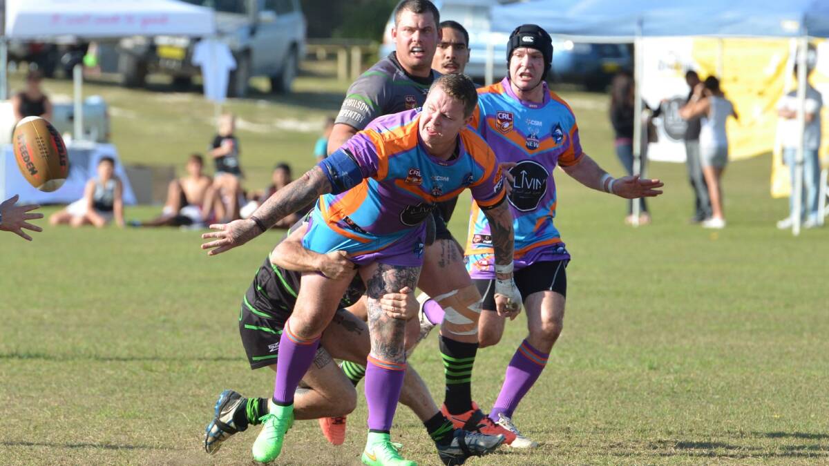 Minor premiers: Marlins tony Duncan manages to pass the ball before being taken down by the Raiders 