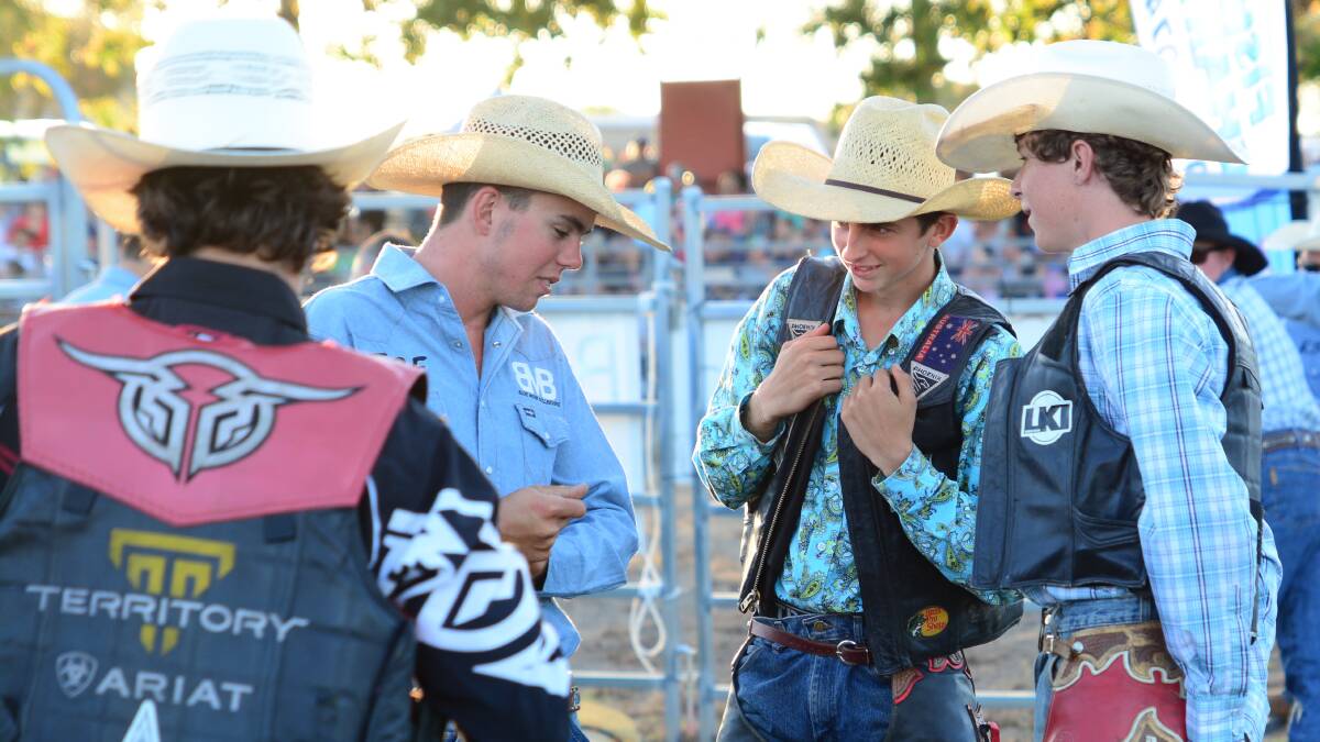 q Riding high: Tom Donnelly (second from right) chats with his fellow competitors before last year’s Farley Brothers Charity Bull Riding event 