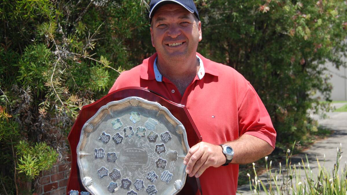It’s all in the wrist: Michael Maynard from South West Rocks holds his winning trophy after taking out the National Left Handed Golf Championships 