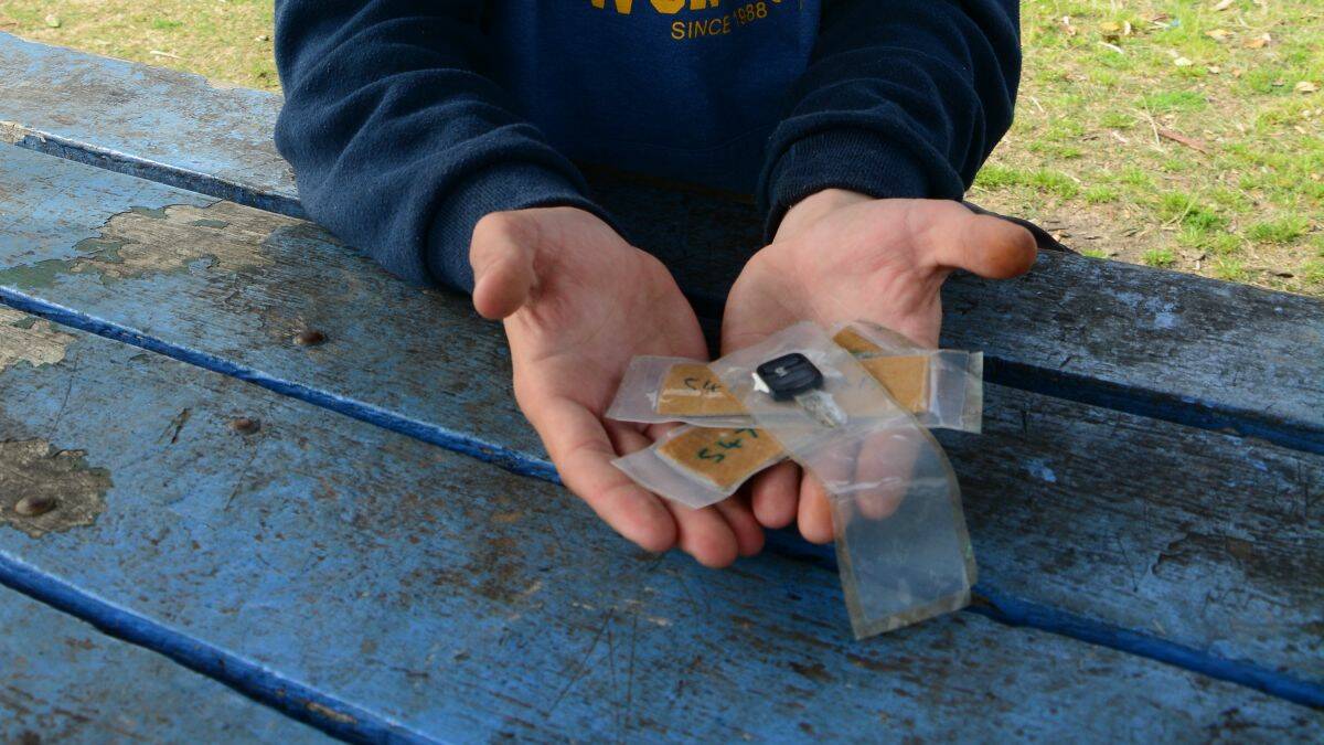 Unlock the puzzle: Mitchell holds the key and the codes sealed in plastic that his son Kieran found at Delicate Beach this week.
