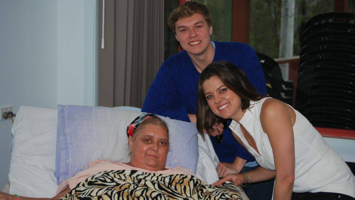 Special performance: Debbie Rudder and her son Jake with country music star Amber Lawrence at the Booroongon Aged Care facility on Tuesday afternoon. Amber flew in from Sydney for a special performance.