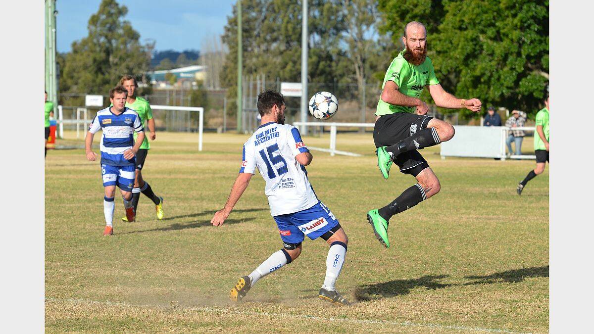 Aerial manoeuvres: Macleay Valley Rangers’ Brent Ryan (no. 15) finds a Wallis Lakes opponent blocking his path at Dangar St, last Saturday. Skipper Steve Morn (watching on) picked up another injury, ruling him out of action for a few weeks. Picture by Penny Tamblyn.