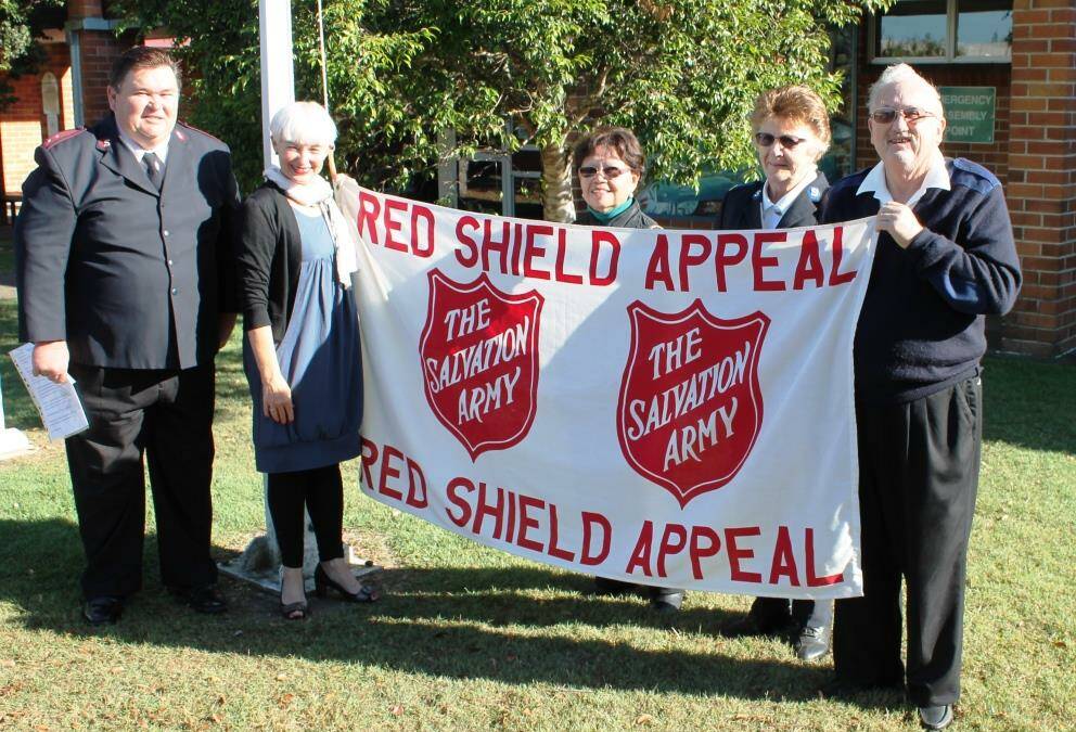 Salvation Army Captain Jeff Bush, Kempsey mayor Liz Campbell and Salvation Army volunteers Pearl Bean, Emily Hawes and Russell Dyson raise the flag to officially launch the Red Shield Appeal 2016  