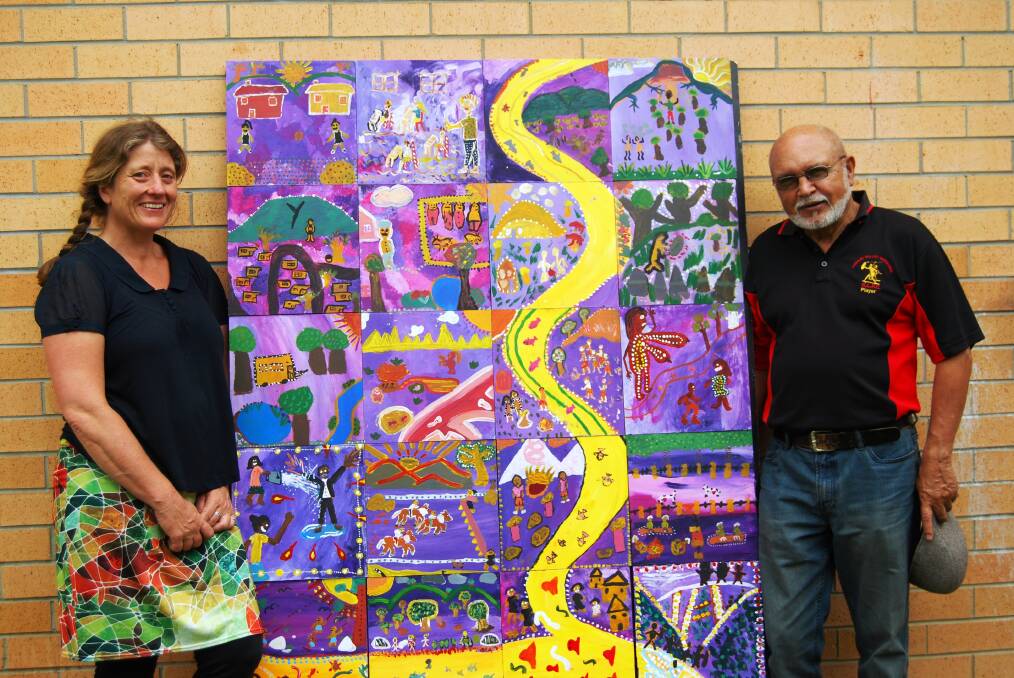 Facilitators Emily King and Uncle Bob Smith with one of the 13 murals which will be on display at Melville High School  