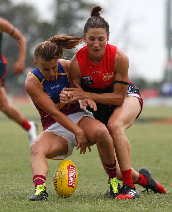 North Coast athlete Nikki Wallace competes for the ball against the Melbourne Demons earlier in the season. Photo: AFL Photos.