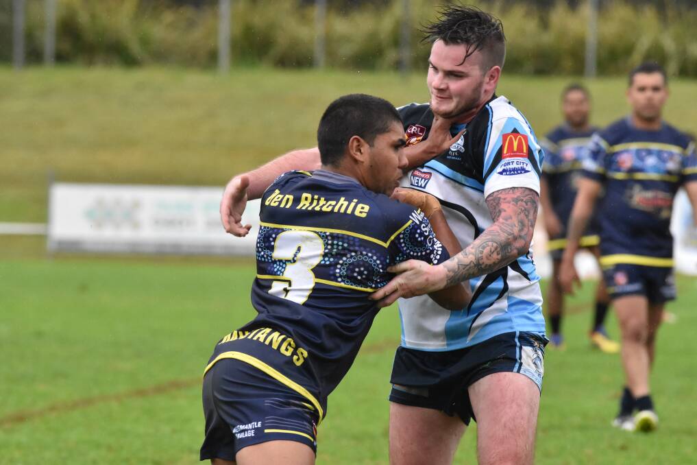 Palm: Macleay Valley Mustang's centre Stephan Blair shrugs off a Port City Breakers defender in their loss on Sunday. Photo: Ivan Sajko.