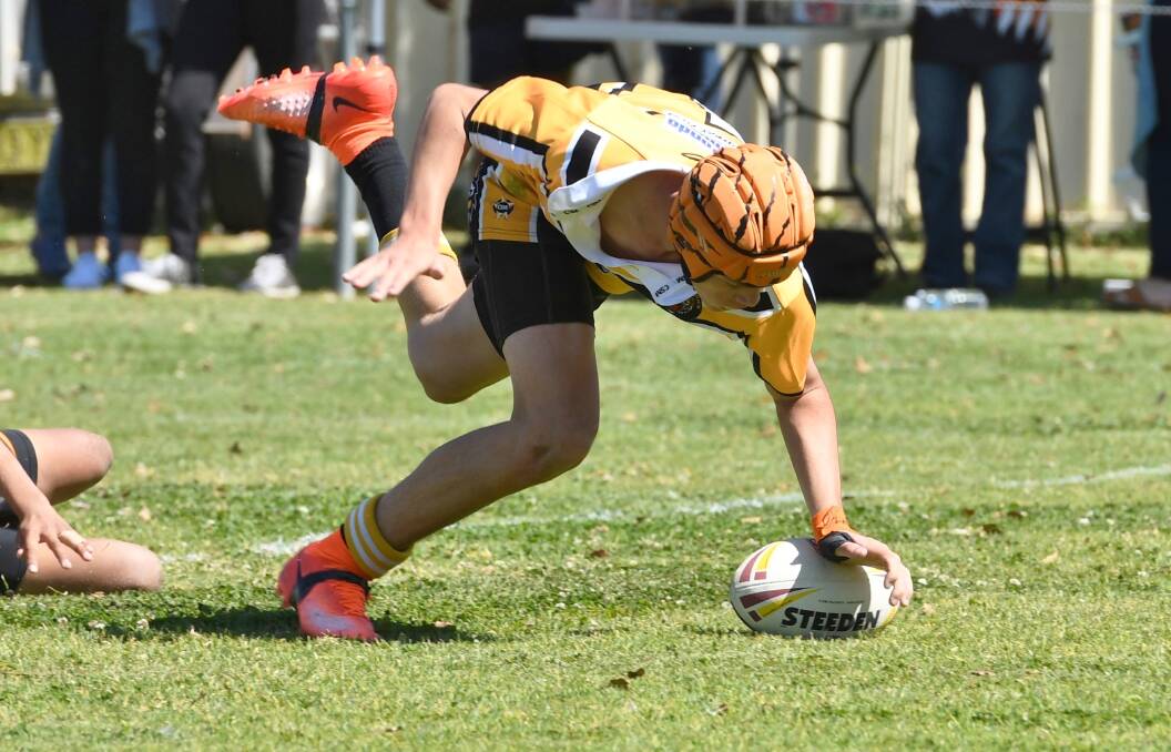 Luke Calthorpe dives over for a try in the U12s grand final. Photo: Penny Tamblyn.