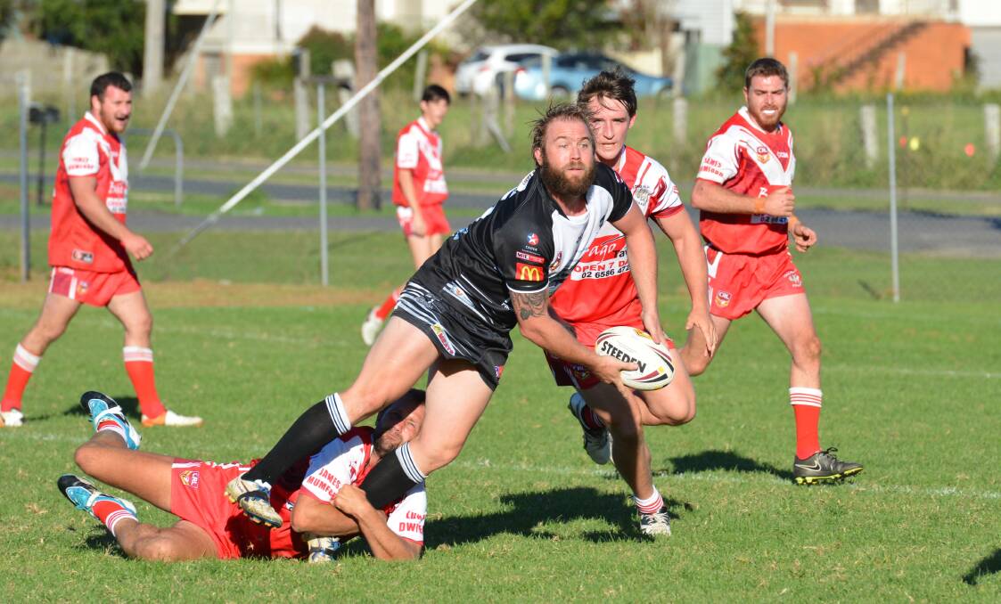 Offload: Lower Macleay Magpies player Luke Dufty looks for support in his side's victory over the Long Flat Dragons. Photo: Penny Tamblyn.