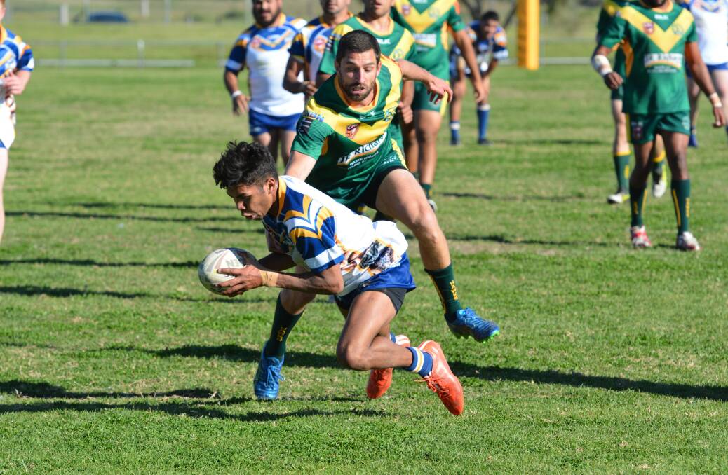 Macleay Valley Mustangs player prepares to put the ball down for a try during the 2016 season.