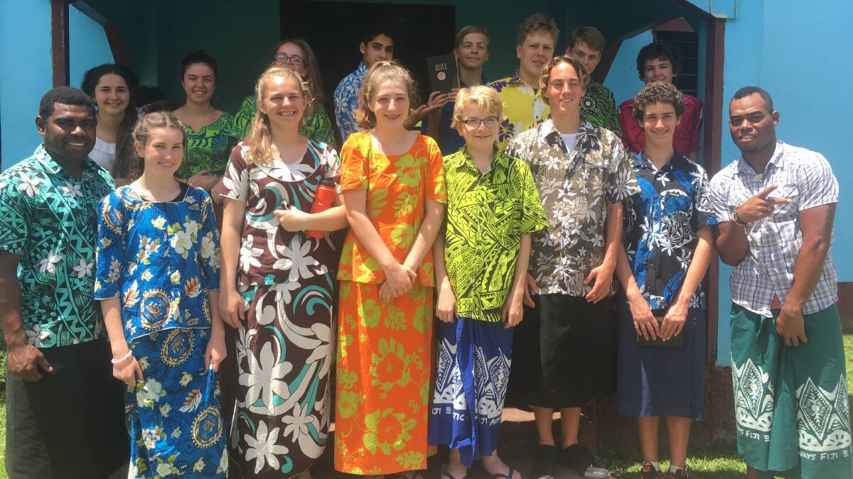 Life changing experience: Students in Fiji with locals, dressed in traditional Fiji attire.