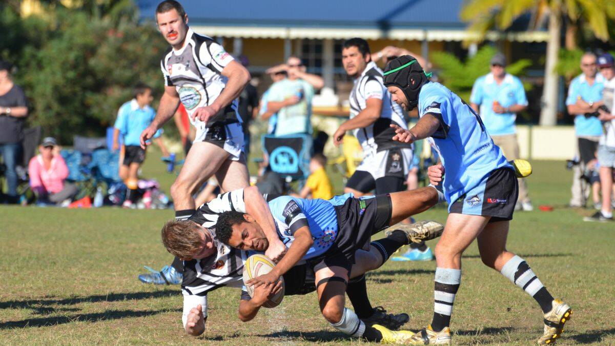 Hang on a second: Magpies co-captain/coach Mick Hughes stops Marlins hooker Joseph Quinlan in his tracks. Photo by Penny Tamblyn