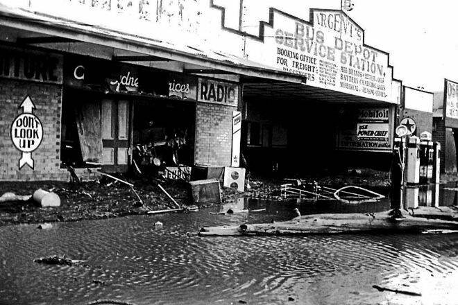 Debris and floodwater in Belgrave St, Kempsey during the 1949 flood. Argent’s bus depot and service station. Pics: Macleay River Historical Society.