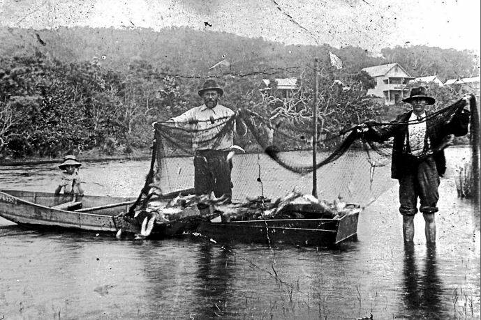An unidentified child with Donald and Bill Baker and their fishing nets in Killick Creek at Crescent Head. The two storey hotel in the background is the New Brighton. Pics: Macleay River Historical Society.