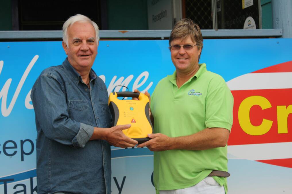 Crescent Head Malibu Club president Barry Price presented a new defibrillator machine to Crescent Head Holiday Park manager Angus Archer on Friday, just two hours before it was used to save a man’s life.