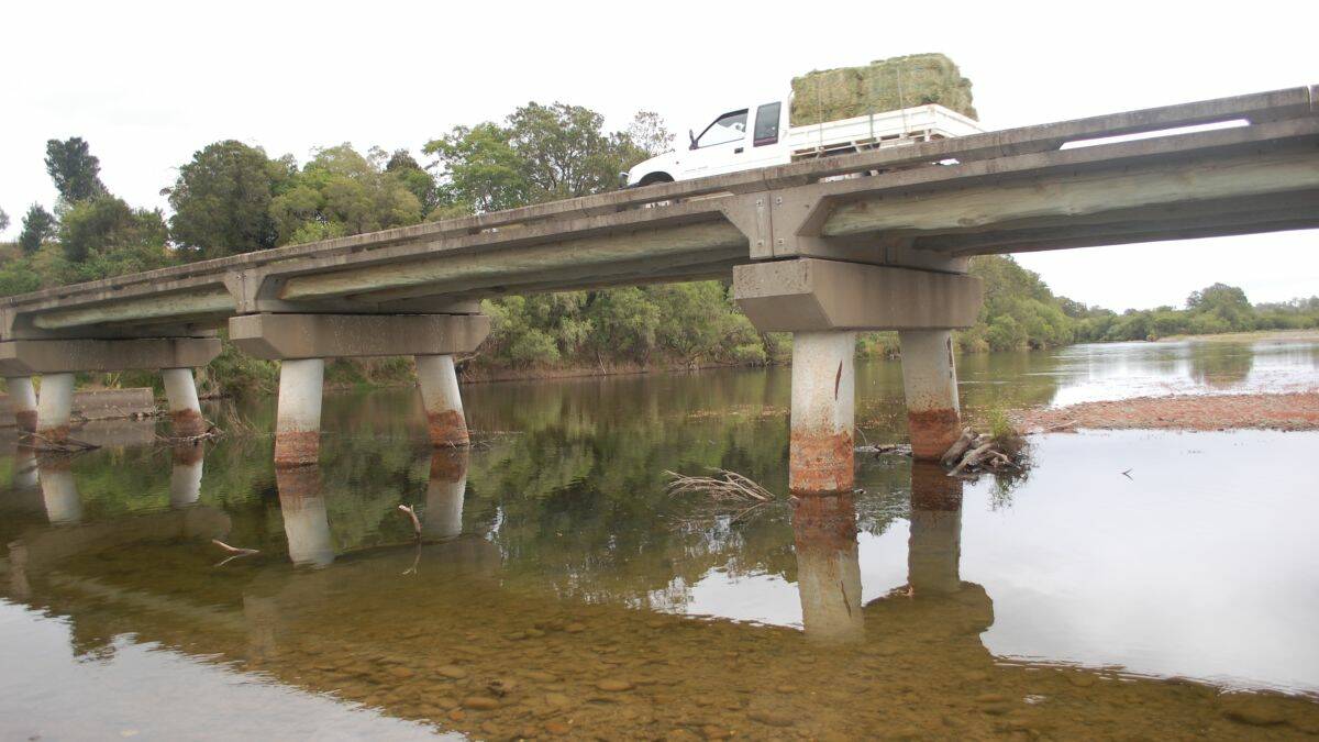 Long dry: a farmer carts feed over the Sherwood bridge yesterday, with the river far below seasonal levels. This bridge is often photographed in flood. Picture by Thom Klein