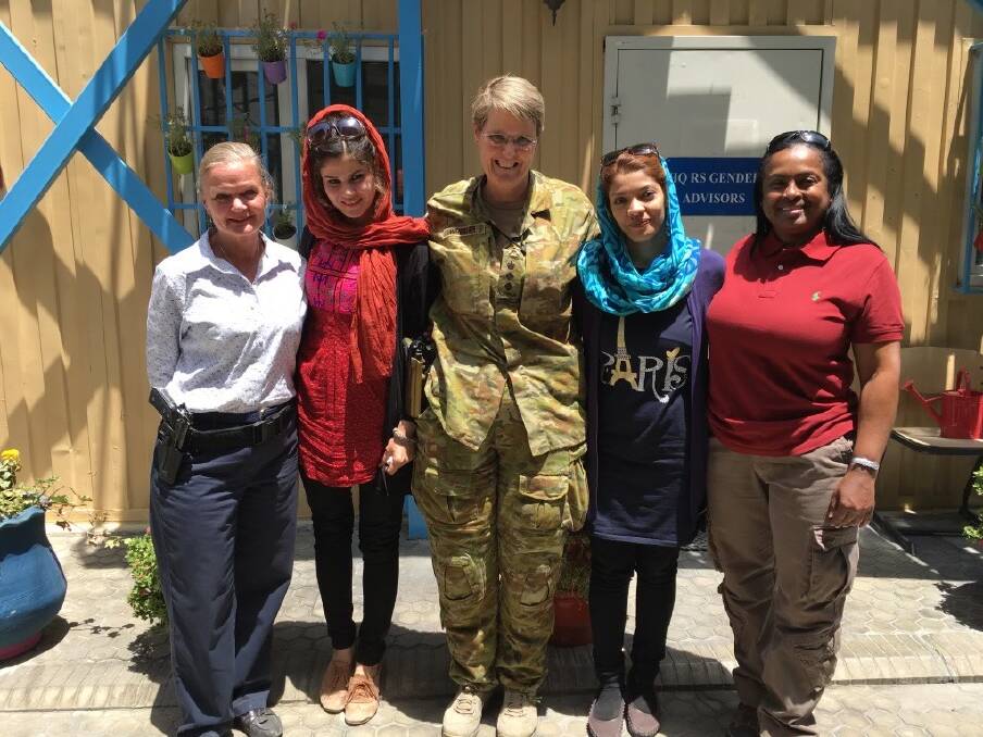 Bronwyn on her posting in Afghanistan with interpreters and staff. Photo supplied