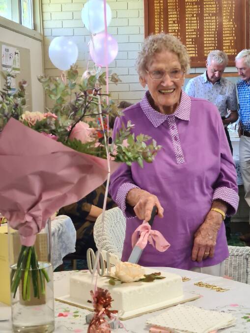 Joy Kyle cutting her 100th birthday cake. Photo: Supplied
