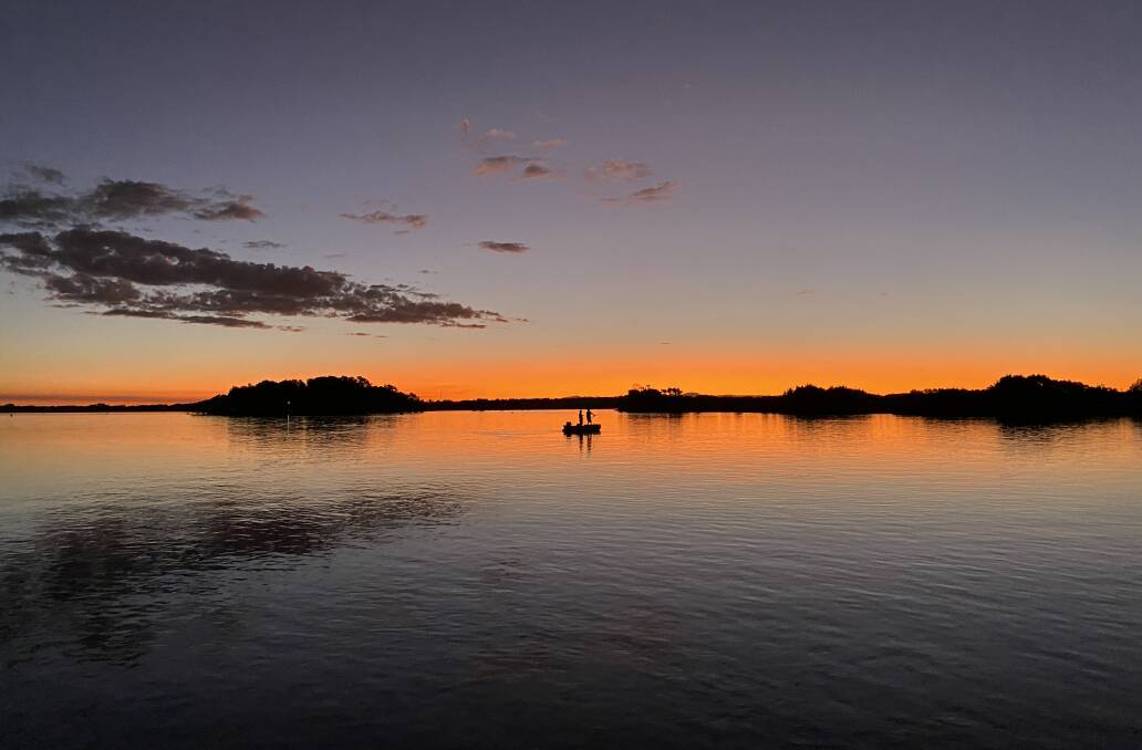 Two people enjoying fishing on the Macleay River at sunset. Picture by Ellie Chamberlain