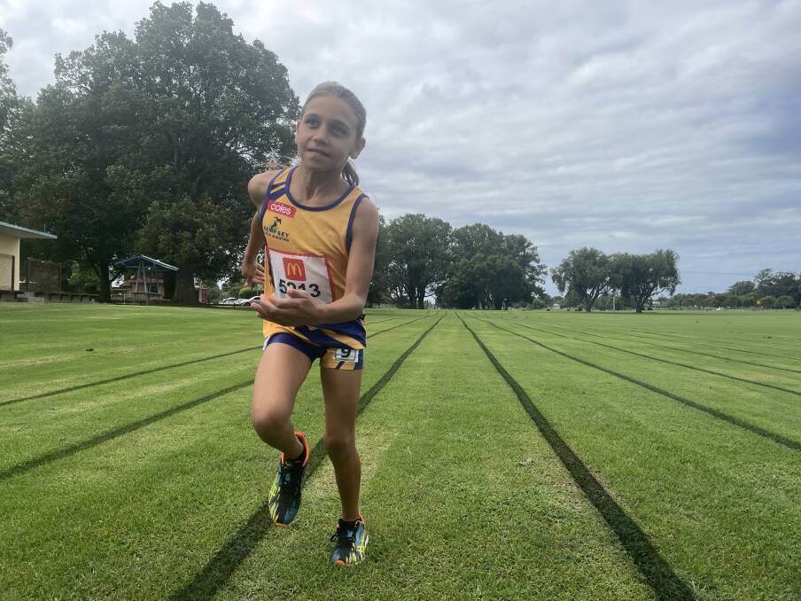 Eight-year-old Ciarra is excited to run on a blue track for the very first time at Sydney Olympic Park. Picture by Ellie Chamberlain.