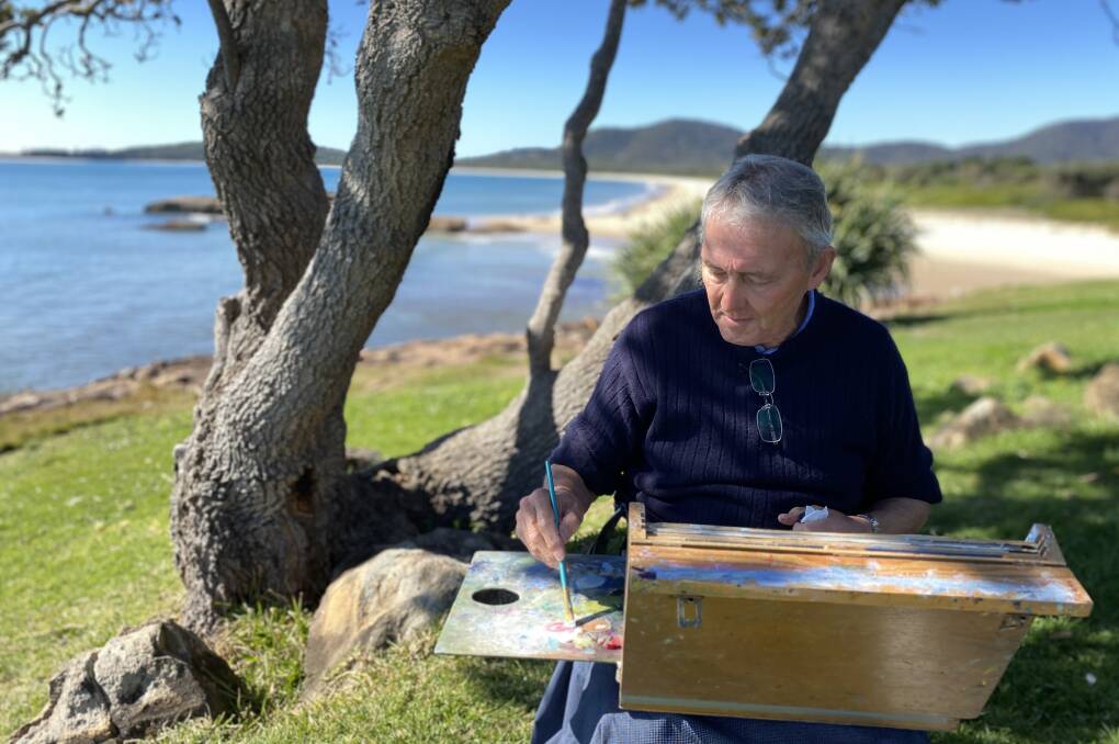 Colin Parry soaks in the sun and sights on South West Rocks headland to spend Sunday afternoon painting a souvenir of his stay. Picture by Ellie Chamberlain