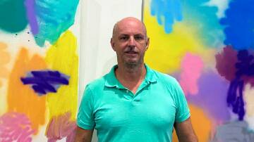 Adam Clarke and his paintings, which were on display earlier this month at Kempsey's Art Hub. Photo: supplied