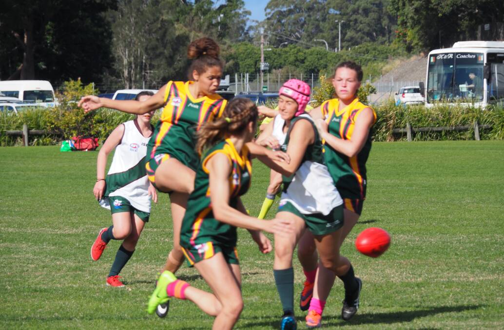 EXPLOSIVE: Macleay Valley Eagle Lizzie Dickson busts through the pack and kicks the sherrin forward. Photo: Sally Wynne.