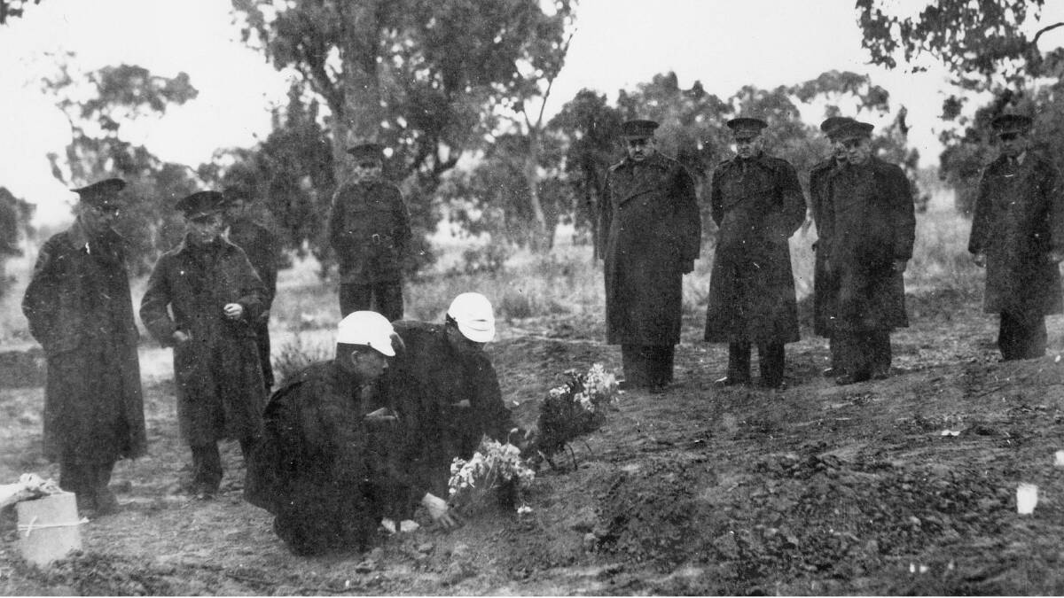 The burial of some of the Japanese prisoners of war who lost their lives in the mass outbreak from B Camp, (the Japanese section), at No. 12 Prisoner Of War compound in the early hours of August 5, 1944. Picture: Australian War Memorial 