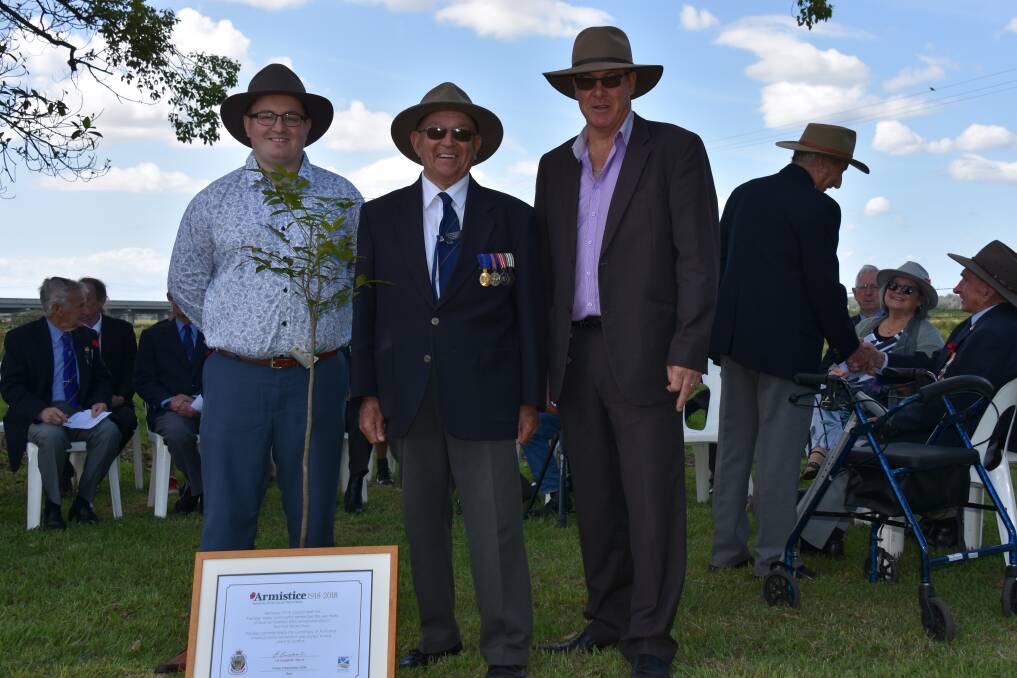 Deputy mayor Ashley Williams, Kempsey-Macleay RSL sub-branch president Terry Hunt and council general manager Craig Milburn with the Crows Ash sapling and a commemorative certificate