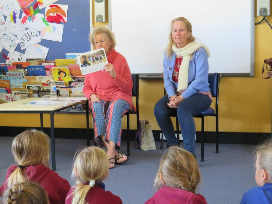 Kay Morrison and Liz Kent give children a sneak preview of the new book at Stuarts Point Primary School