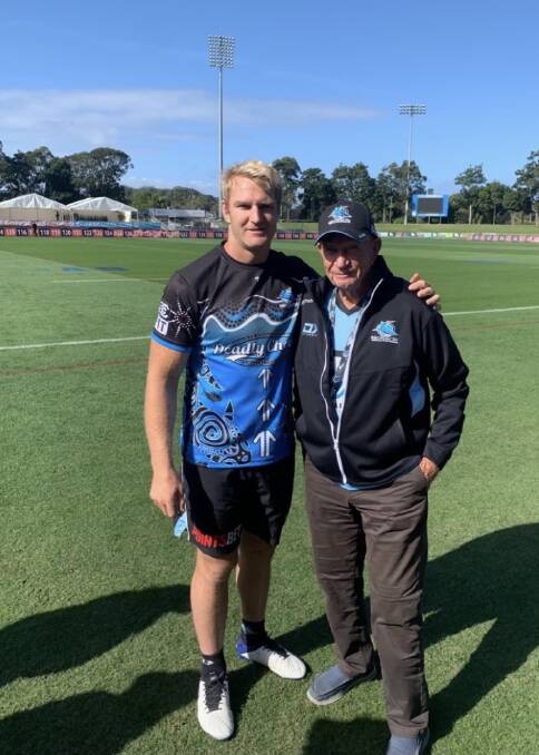 Aiden with his grandfather and No.1 supporter David Tolman from Gladstone at the Captain's Run the day before the game against Gold Coast